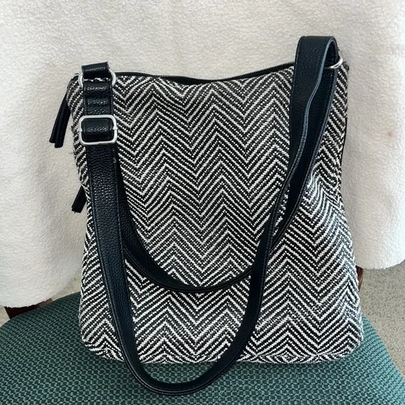 Black and white purse with two front zipper pockets. - Picture 2 of 3